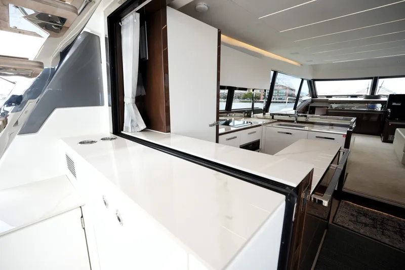 Slide: The Image of Luxurious interior of 2023 Prestige 690 yacht featuring modern kitchen and sleek design. - 53