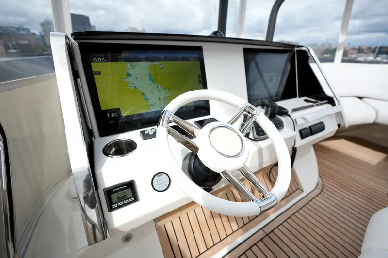 Slide: The Image of Cockpit of 2023 Prestige 690 yacht with modern navigation system and sleek steering wheel. - 46