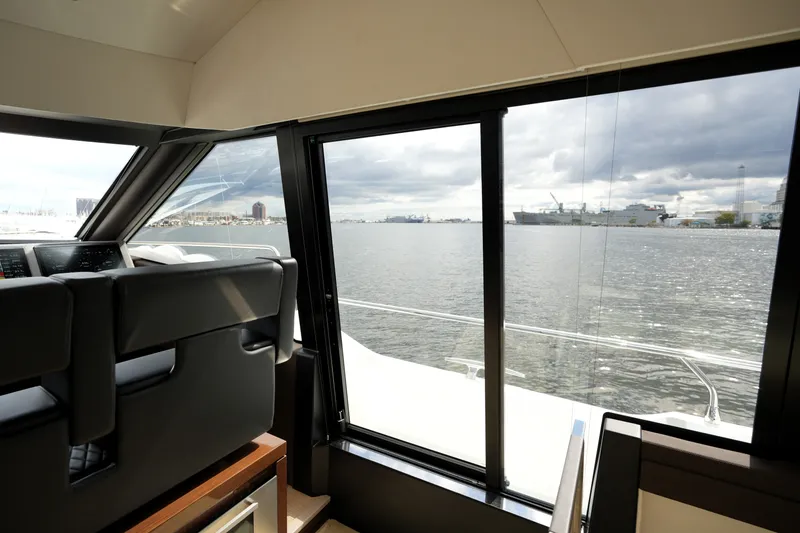 Slide: The Image of Interior view from 2023 Prestige 690 yacht, showcasing modern design and waterfront scenery. - 74