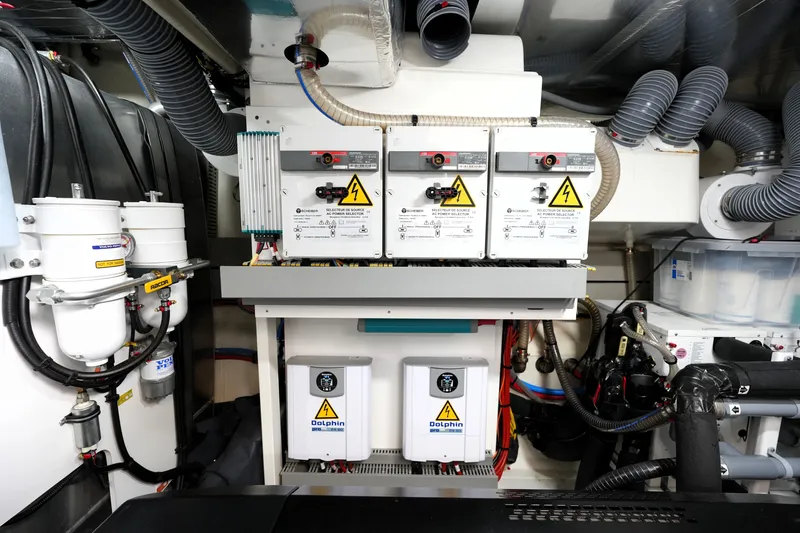 Slide: The Image of Engine room of 2023 Prestige 690 yacht with electrical panels and equipment. - 131