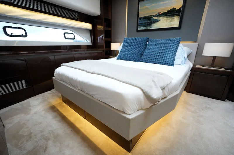 Slide: The Image of Luxurious bedroom interior of 2023 Prestige 690 yacht with modern decor and ambient lighting. - 90