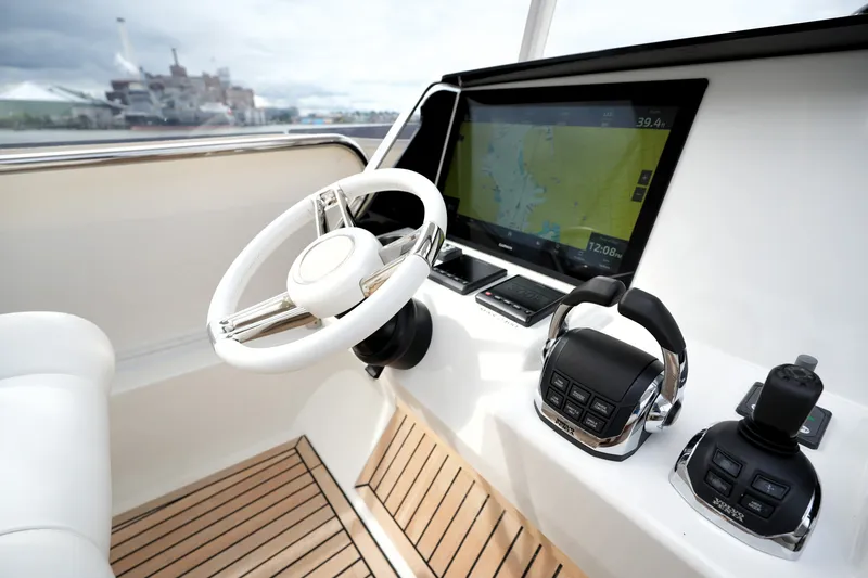 Slide: The Image of Cockpit of 2023 Prestige 690 yacht with steering wheel and navigation display. - 47