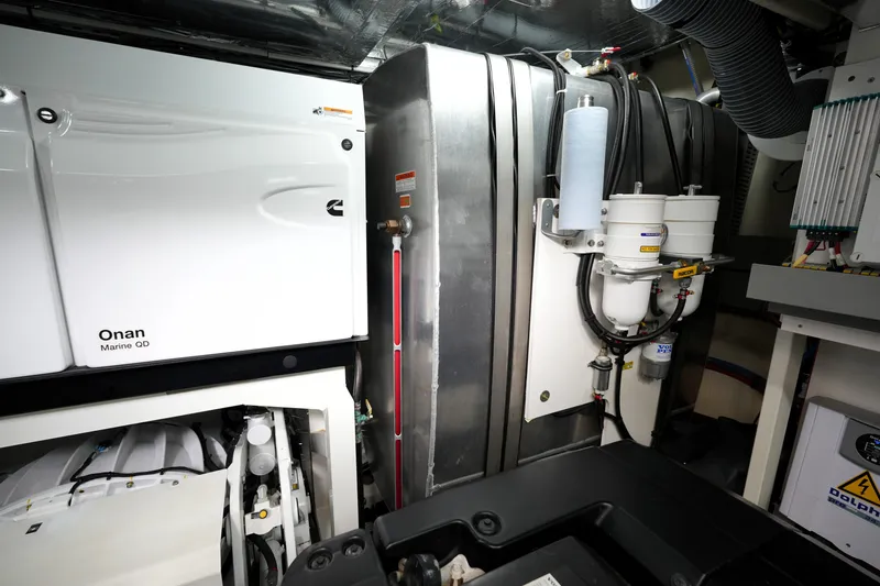Slide: The Image of Engine room of 2023 Prestige 690 yacht featuring Onan Marine QD generator. - 132