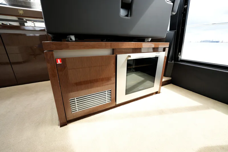 Slide: The Image of Luxurious interior of 2023 Prestige 690 yacht featuring sleek cabinetry and modern appliances. - 71