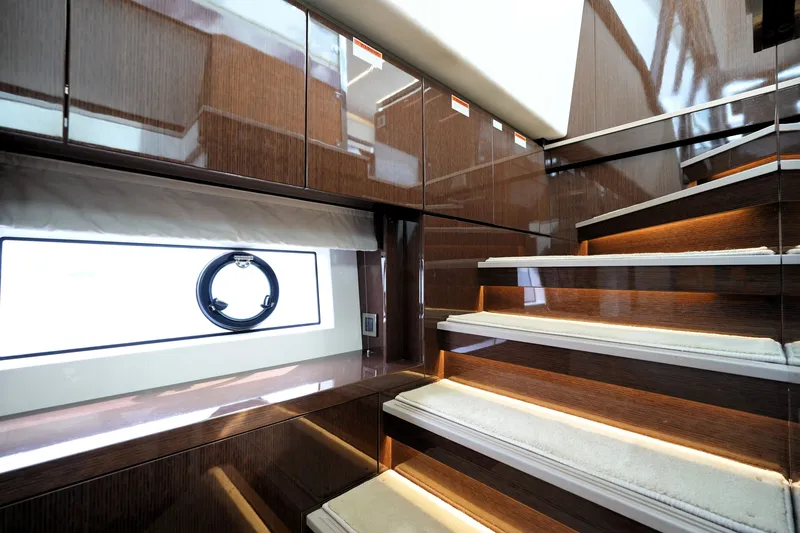 Slide: The Image of Luxurious interior staircase of 2023 Prestige 690 yacht with elegant wood finish. - 102