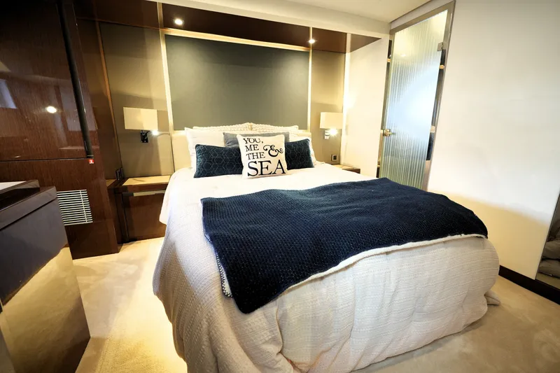 Slide: The Image of Luxurious bedroom interior in 2023 Prestige 690 yacht with elegant bedding and modern design. - 104