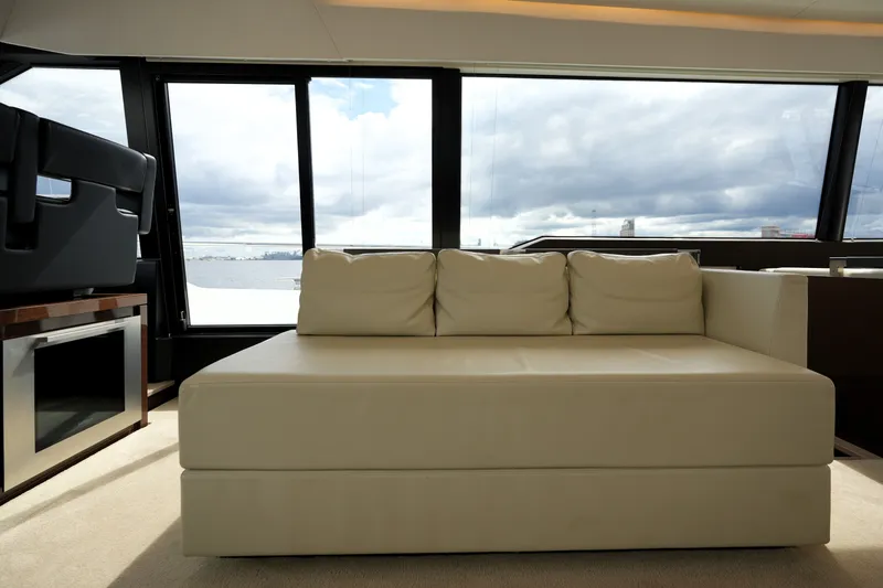 Slide: The Image of Luxurious interior of 2023 Prestige 690 yacht with cream sofa and panoramic windows. - 70