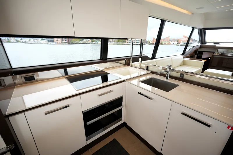 Slide: The Image of Modern kitchen interior on 2023 Prestige 690 yacht with sleek countertops and large windows. - 55