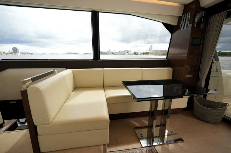 Slide: The Image of Luxurious interior of 2023 Prestige 690 yacht with cream seating and sleek black table. - 61