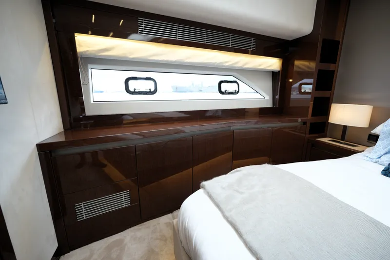 Slide: The Image of Luxurious interior of 2023 Prestige 690 yacht with elegant wood cabinetry and modern window design. - 93