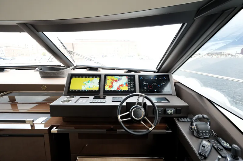 Slide: The Image of Luxurious 2023 Prestige 690 yacht cockpit with advanced navigation displays and controls. - 78