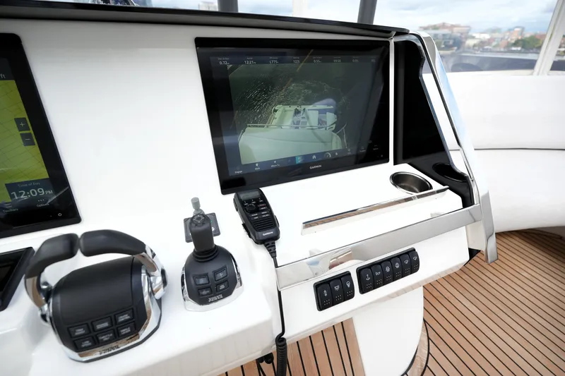 Slide: The Image of Control panel of 2023 Prestige 690 yacht with navigation screens and controls. - 48