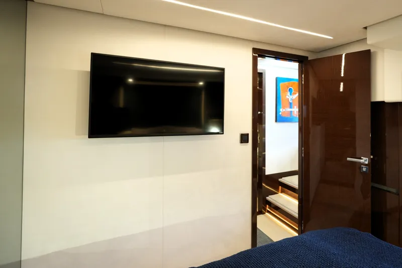 Slide: The Image of Luxurious interior of 2023 Prestige 690 yacht with wall-mounted TV and modern decor. - 107