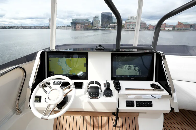 Slide: The Image of Cockpit of 2023 Prestige 690 yacht with navigation screens and steering wheel. - 44