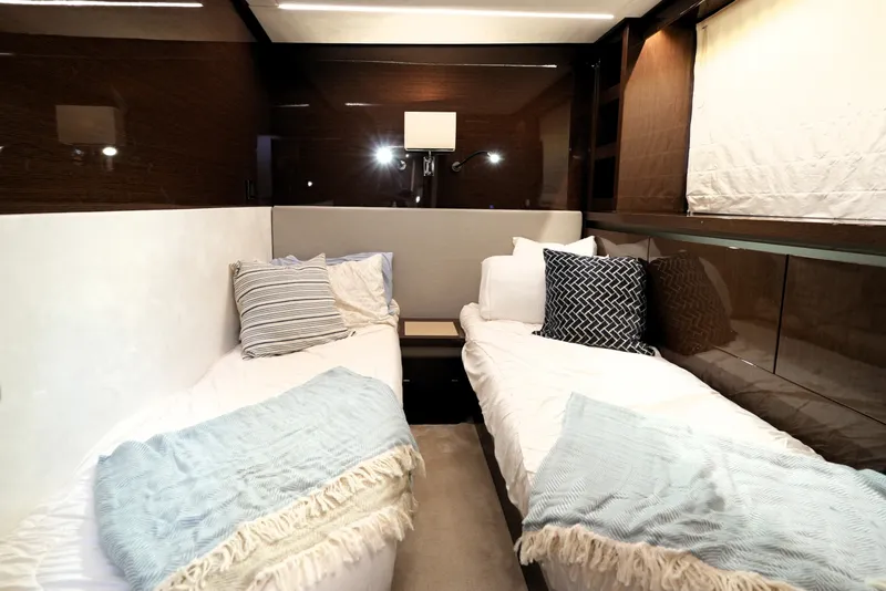 Slide: The Image of Luxurious twin cabin interior of 2023 Prestige 690 yacht with elegant bedding and modern decor. - 113