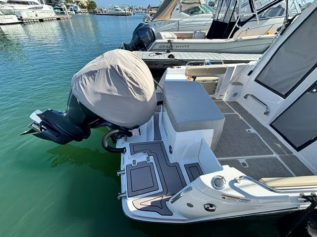 Slide: The Image of The image shows the stern of a 2026 Cutwater C-248 Coupe docked. The engine is covered. - 20