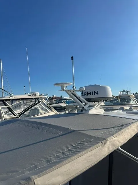 Slide: The Image of A modern boat with a Garmin radar on the roof, surrounded by other boats in the marina. - 24