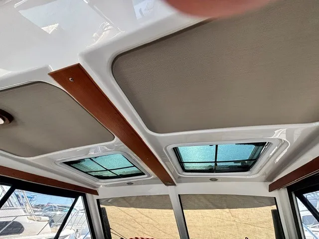 Slide: The Image of Interior view of the Cutwater C-248 Coupe with two skylights and wood accents. - 48