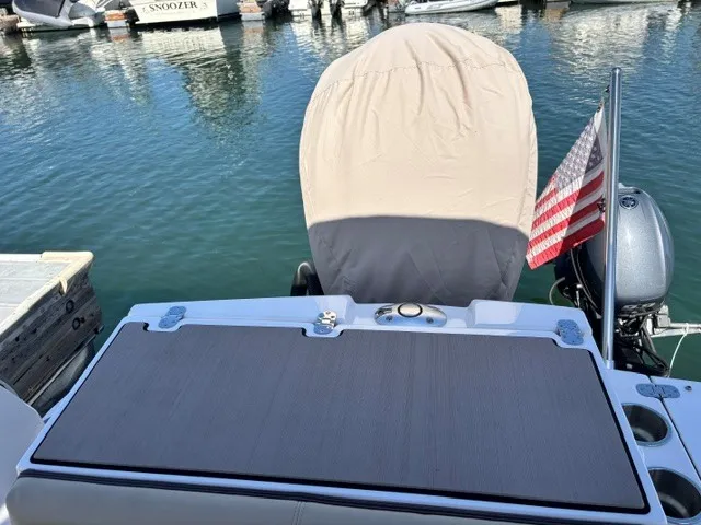 Slide: The Image of The stern of a 2026 Cutwater C-248 Coupe with a cover and an American flag. - 17