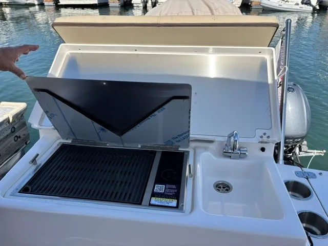 Slide: The Image of The 2026 Cutwater C-248 Coupe features an outdoor kitchen with a grill and sink at the stern. - 18