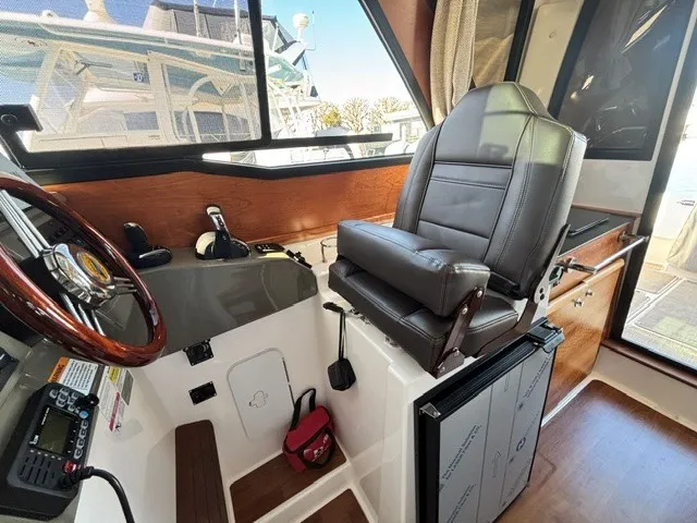 Slide: The Image of Interior of a Cutwater C-248 Coupe featuring a leather seat and helm console. - 32