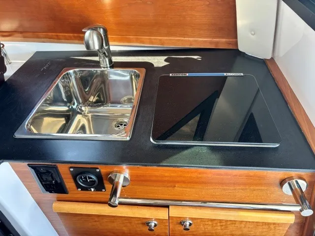 Slide: The Image of The 2026 Cutwater C-248 Coupe's galley features a sink and a cooktop. - 50