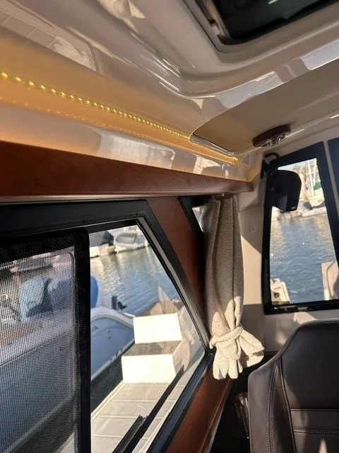 Slide: The Image of Interior view of a Cutwater C-248 Coupe with sleek wood trim and a window with a curtain. - 40