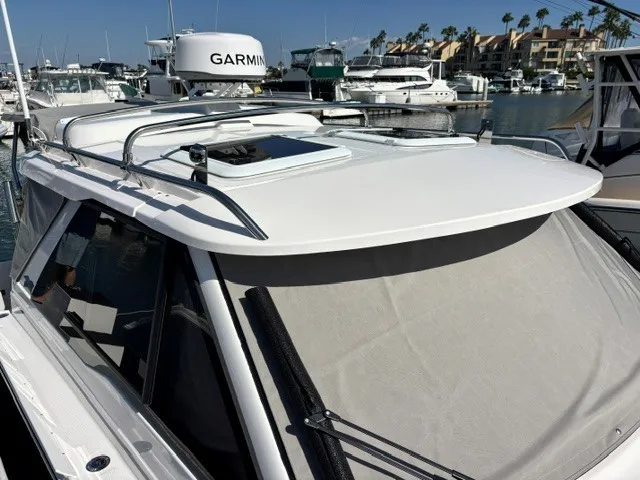 Slide: The Image of The image shows a 2026 Cutwater C-248 Coupe boat in a marina, surrounded by other boats. - 26