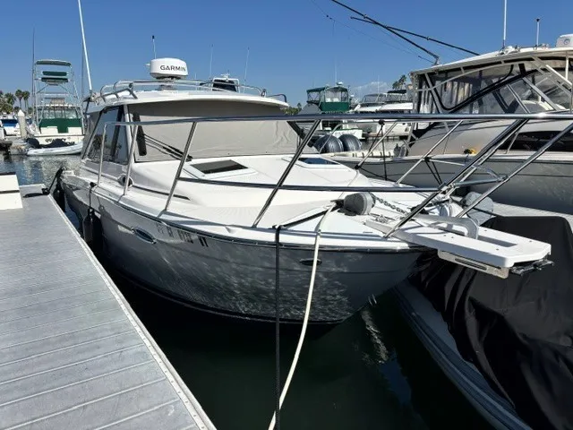 The Image of A 2026 Cutwater C-248 Coupe docked. It features a modern design and is equipped with Garmin radar. - 1