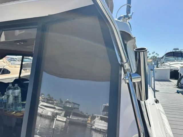 Slide: The Image of A modern boat with shiny metal accents docked at a sunny marina. - 16