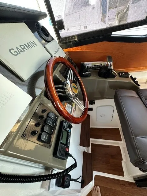 Slide: The Image of The cockpit of the 2026 Cutwater C-248 Coupe features a sleek steering wheel and modern instruments. - 42