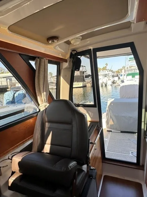 Slide: The Image of Interior of a Cutwater C-248 Coupe with leather seat and view of the marina. - 41
