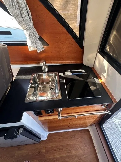 Slide: The Image of The 2026 Cutwater C-248 Coupe's galley features a sink and stove. - 44