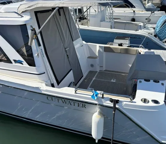 Slide: The Image of A modern 2026 Cutwater C-248 Coupe in the water, featuring a spacious cockpit and sunshade. - 11