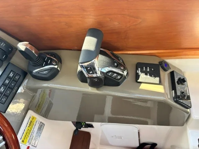 Slide: The Image of Close-up of a Cutwater C-248 Coupe helm with modern controls and wood paneling. - 36