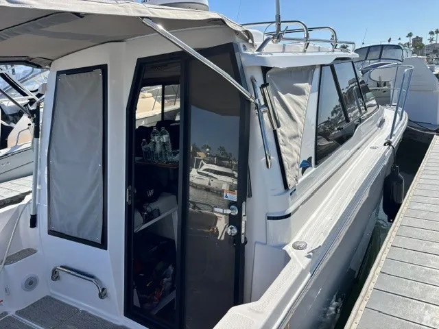 Slide: The Image of A modern boat with an enclosed cabin and large windows docked at a pier. - 15