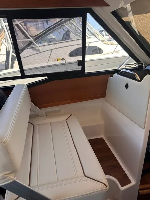 Slide: The Image of Interior of a Cutwater C-248 Coupe with white upholstery and wood accents. - 39