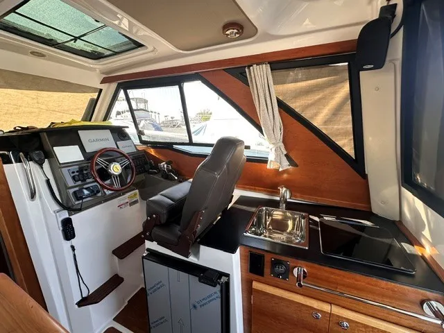 Slide: The Image of Interior of the 2026 Cutwater C-248 Coupe with helm, sink, and stove. - 43