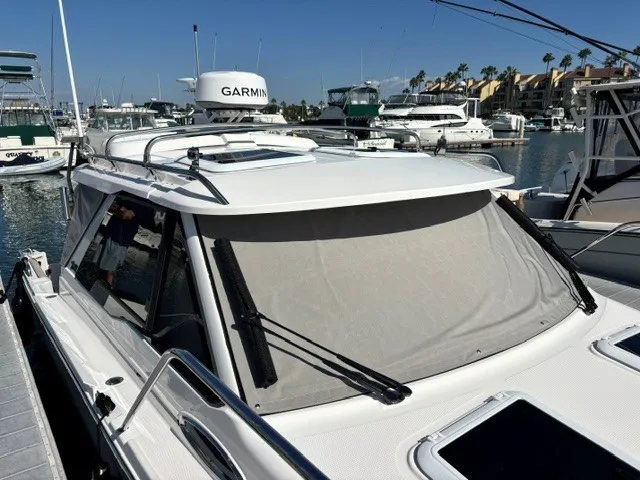 Slide: The Image of The 2026 Cutwater C-248 Coupe is docked in a marina. It features a modern design with Garmin radar. - 27
