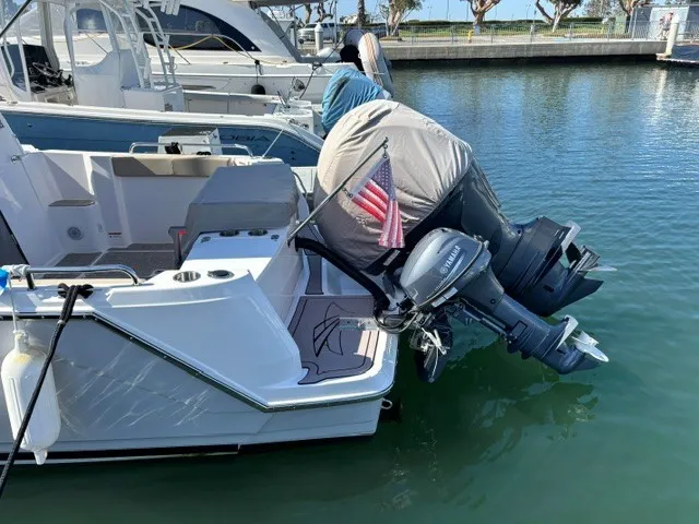 Slide: The Image of A 2026 Cutwater C-248 Coupe is docked. The outboard motor is covered. - 29