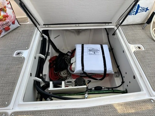 Slide: The Image of An open storage compartment on a boat reveals ropes and equipment. - 21