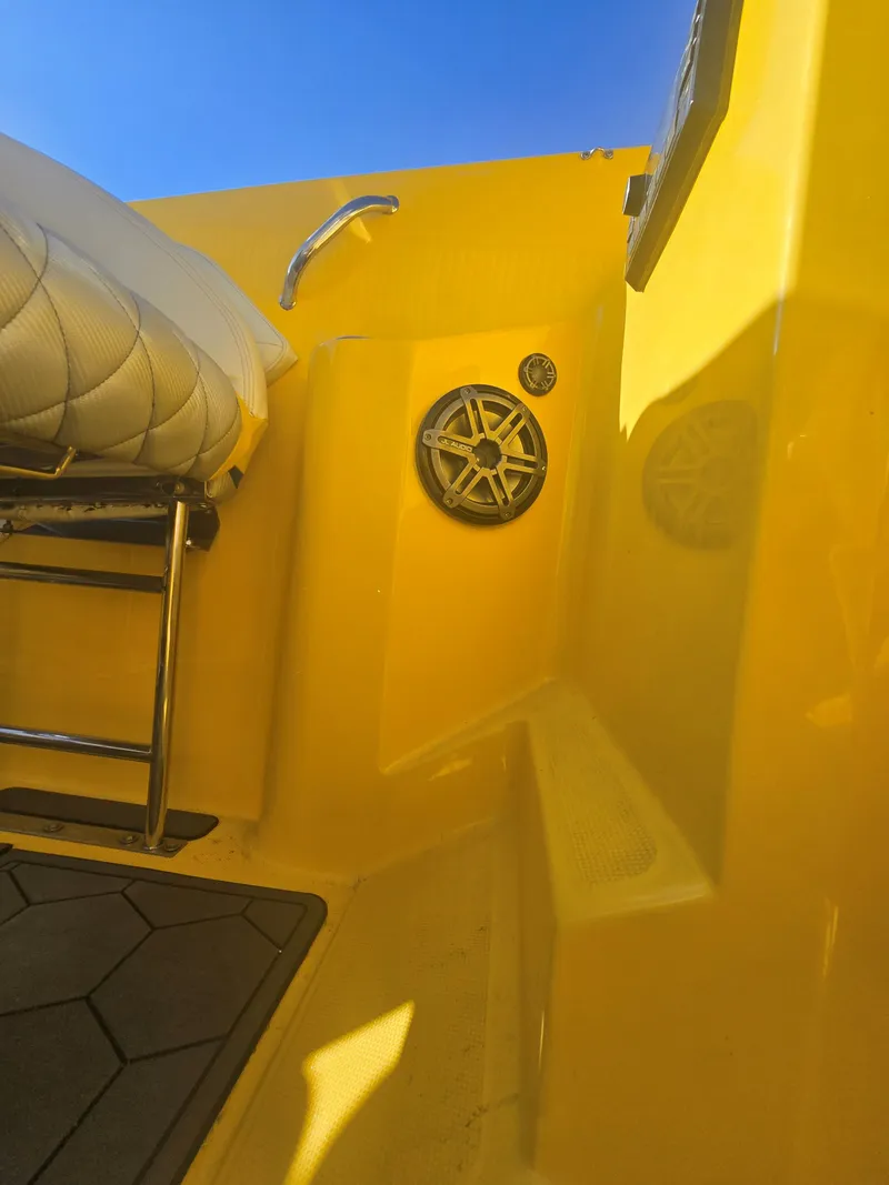 Slide: The Image of Close-up of a yellow boat deck with a speaker and white seat. - 9