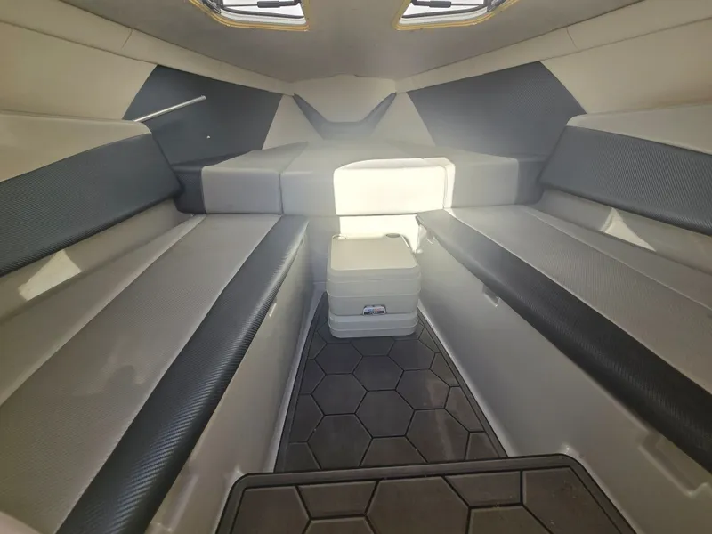 Slide: The Image of The image shows the interior of a 2007 Baja 26 Outlaw with cushioned benches and a small cooler. - 14