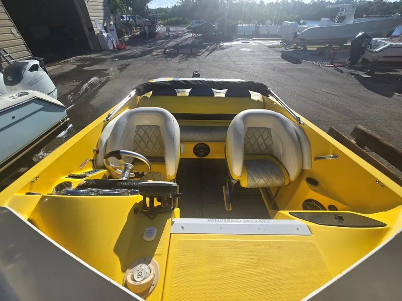 Slide: The Image of The image shows the cockpit of a yellow 2007 Baja 26 Outlaw with two cushioned seats. - 7