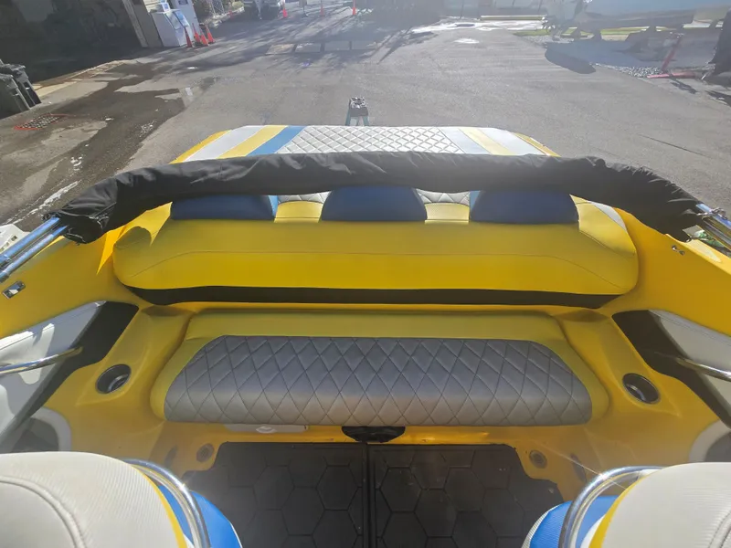 Slide: The Image of The image shows the rear of a 2007 Baja 26 Outlaw boat with yellow and blue seating. - 6