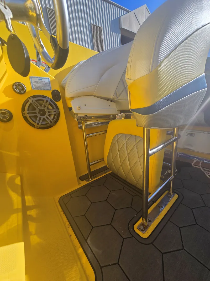 Slide: The Image of The image shows the interior of a 2007 Baja 26 Outlaw with yellow accents and white seats. - 8