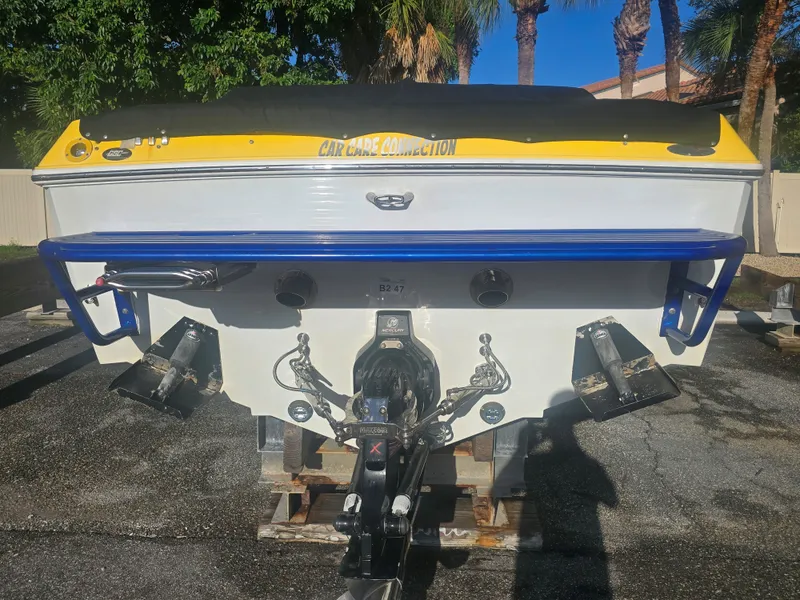Slide: The Image of The stern of a 2007 Baja 26 Outlaw with yellow and blue accents. - 5