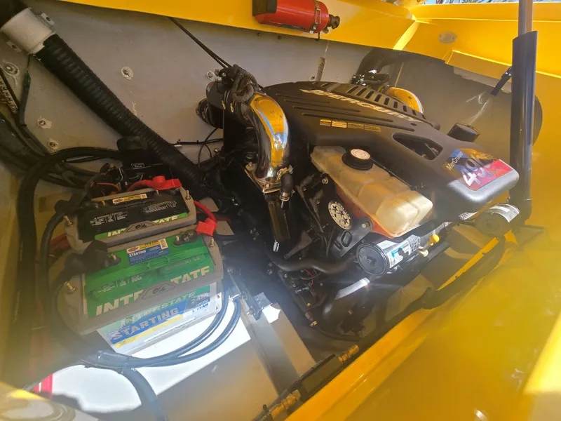 Slide: The Image of The engine compartment of a 2007 Baja 26 Outlaw with a powerful engine and a battery. - 17