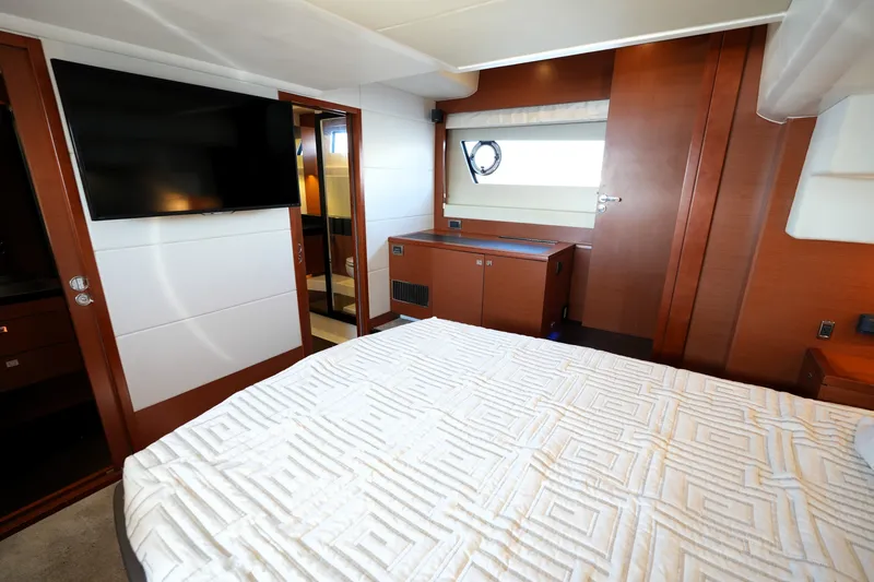 Slide: The Image of Luxurious interior of 2016 Prestige 550 yacht with modern bedroom and flat-screen TV. - 78