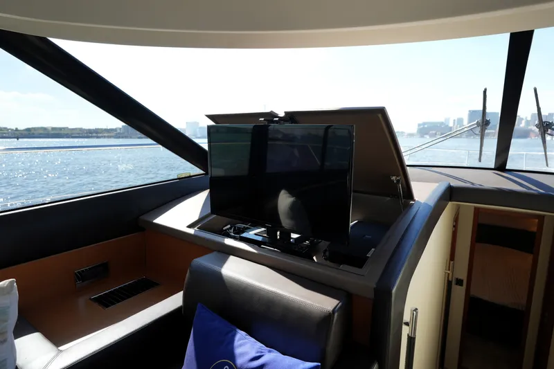 Slide: The Image of Interior of 2016 Prestige 550 yacht with retractable TV and scenic water view. - 63